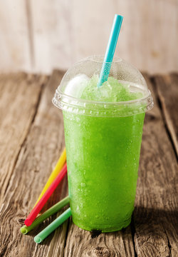 Green Slushie Drink In Plastic Cup With Straws