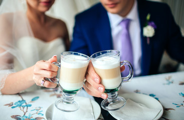 Bride and groom drinking coffee