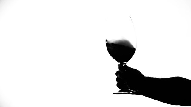 Wine glass with red wine, white, silhouette, slowmotion