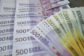 Cash Euro five hundred banknotes spread out on the table.