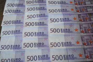 Cash Euro five hundred banknotes spread out on the table.