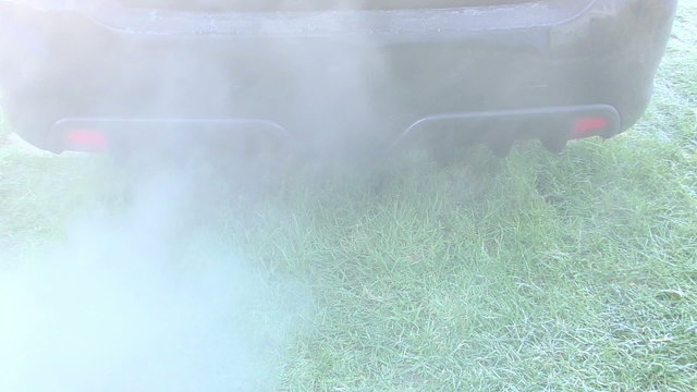Car exhaust fumes on a cold frosty day causing pollution