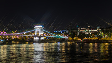 Fototapeta na wymiar Night view on Szechenyi Chain Bridge over Danube river in Budapest, Hungary. Cross Filter Effect
