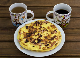 The omelet in the pan, coffee, tea, top view