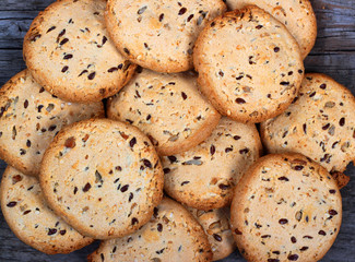 Biscuits with cereals on old wooden table