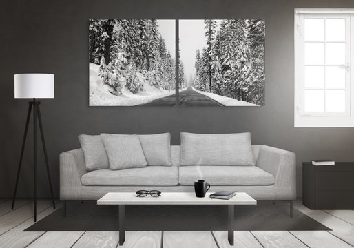 Winter art canvas on wall. Window, sofa, lamp, plant, glasses, book, coffee on table in living room interior. 