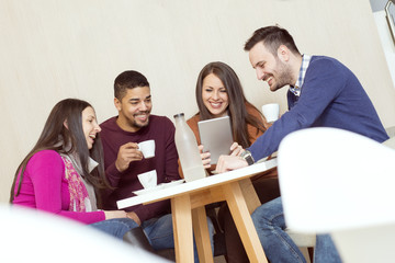 Friends smiling and sitting in a coffee shop