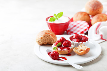 Wholegrain buns and chia seeds strawberry jam for breakfast, selective focus
