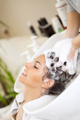 Hairdresser washing hair © ivanko80