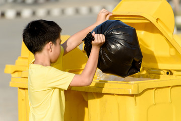Boy carry garbage in bag for eliminate to the bin