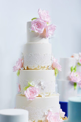 Fototapeta na wymiar Wedding cake decorated with pink peonies