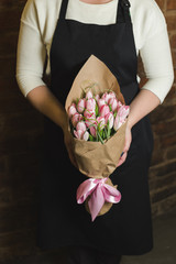 Bouquet of pink tulips in paper wrapper
