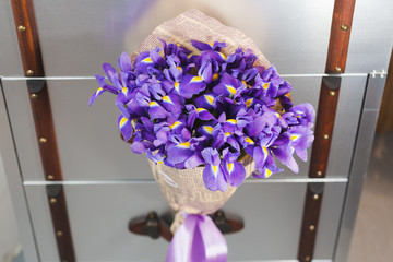 Bouquet of violet irises in paper wrapper