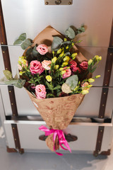 Bouquet of pink and yellow roses in paper wrapping