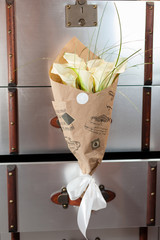 Bouquet of white callas in a paper wrapper