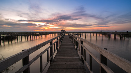 Fototapeta na wymiar Wooden bridges in the sunset sky
