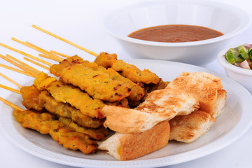 Traditional Thai style, Grilled pork satay with peanut sauce and toast.
