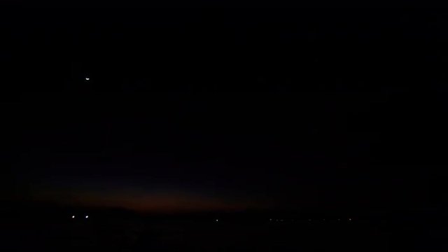 Getting Dark after Sunset Star over Sea LIghts on Horizon