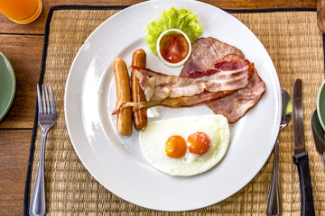 English breakfast with fried eggs, sausages and bacon