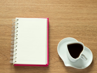 Fototapeta na wymiar Heart shape of cup with coffee and heart shape of plate with opened book for diary. Love coffee. Top view. Happy Valentines Day background.