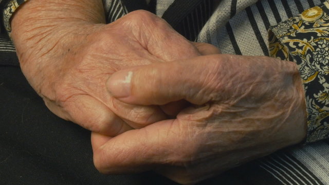 Senior woman massages painful hands