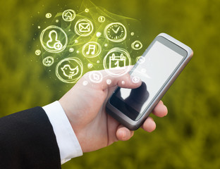 Hand holding smartphone with mobile app choices