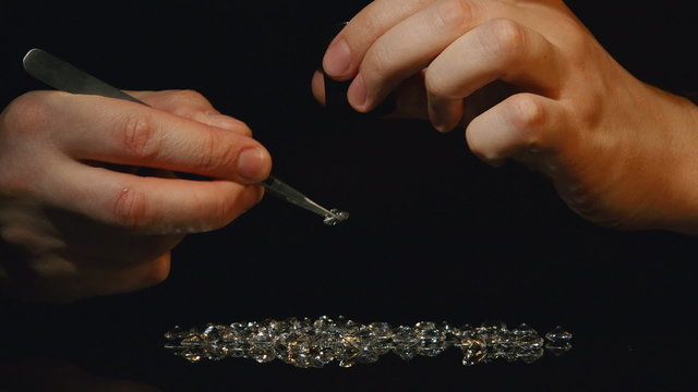 An appraiser gemstones pours diamonds and crystals on the table and appraises their 

