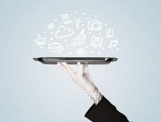 Waiter holding tray with media icons