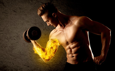 Muscular bodybuilder lifting weight with flaming biceps concept