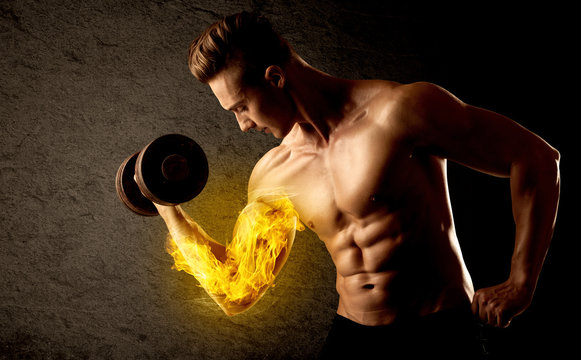 Muscular bodybuilder lifting weight with flaming biceps concept