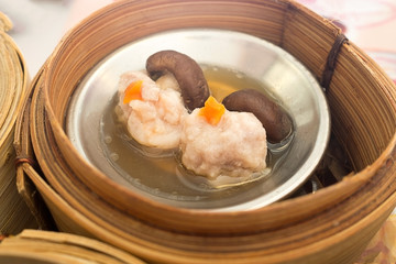 Yumcha, various chinese steamed dumpling in bamboo steamer in chinese restaurant. Dimsum in the steam basket, Hong kong local food.