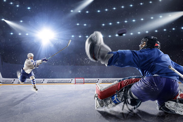 Obraz na płótnie Canvas Hockey players shoots the puck and attacks