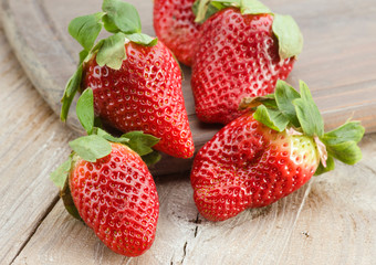 group of large strawberries on rustic kitchen table