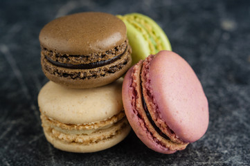 Stack of macaroons on a scratched old chalkboard background