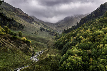 river valley in the Caucasus mountains in cloudy weather - obrazy, fototapety, plakaty