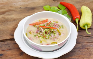 Sour and Sweet curry pickled pork with Thai spices in coconut milk. Moo Som soup of Thai food 
