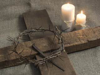 Top view of a holy cross, crown of thorns and candles on a burla