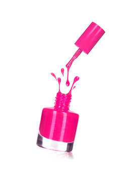 Pink Nail Polish Bottle With Splash Isolated On White