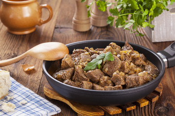 Beef stew - wooden background