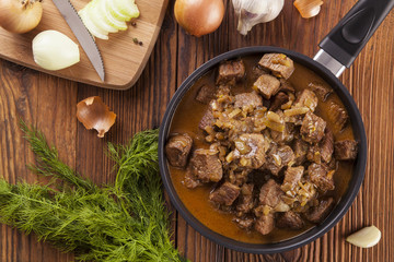 Beef stew - wooden background