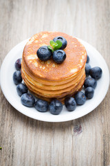 Stack of pancakes with blueberry and fresh berry.