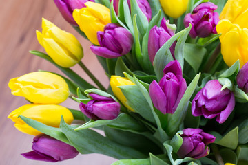 Purple and yellow tulip bouquet. More tulip on the grey backgrou