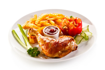 Grilled chicken legs with chips and vegetables 