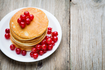 Stack of pancakes with blueberry and fresh berry.
