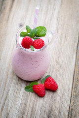 Raspberry milk shake with mint decor.