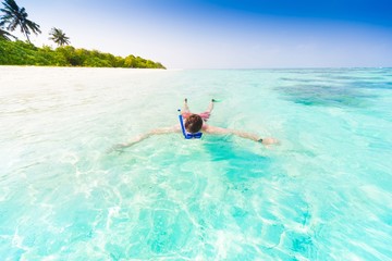 Maldives, man snorkeling