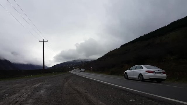 Cars in the famous mountain road Chalus during winter - the foggy and cloudy mountain.