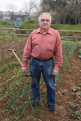 portrait of a retired man in his vegetable garden