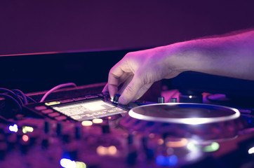 Dj mixes the track in the nightclub at party - music concept