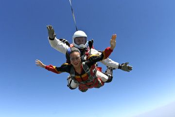 Tandem jump. The girl with the instructor in freefall.